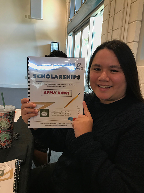 Person holding a scholarship booklet