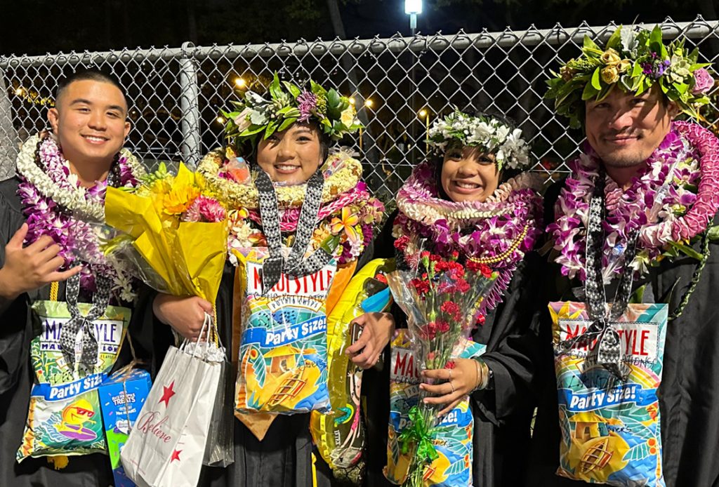 Group photo of students wearing lei at graduation